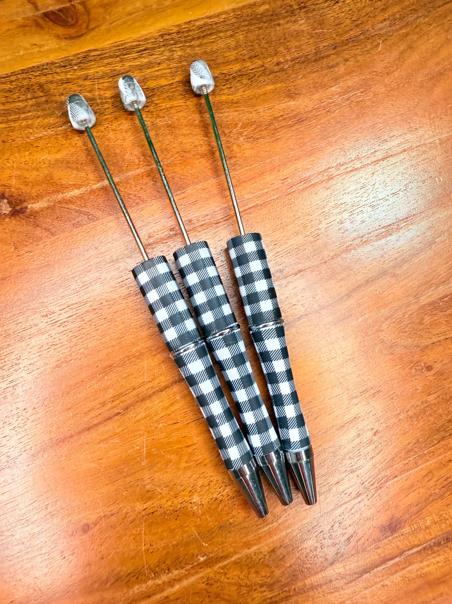 White and black plaid pens